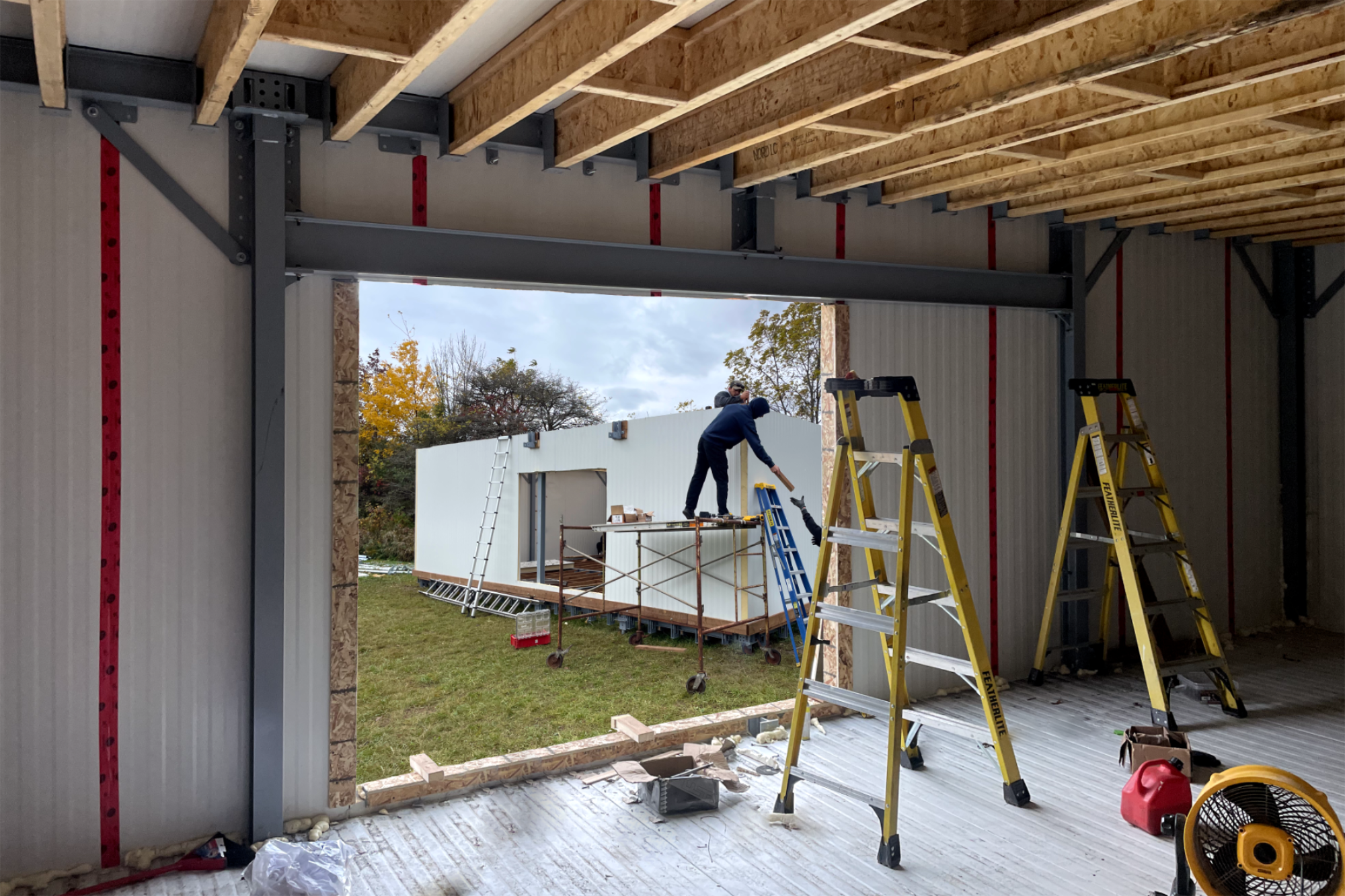 Construction workers assembling Buildlite modular units for disaster relief housing