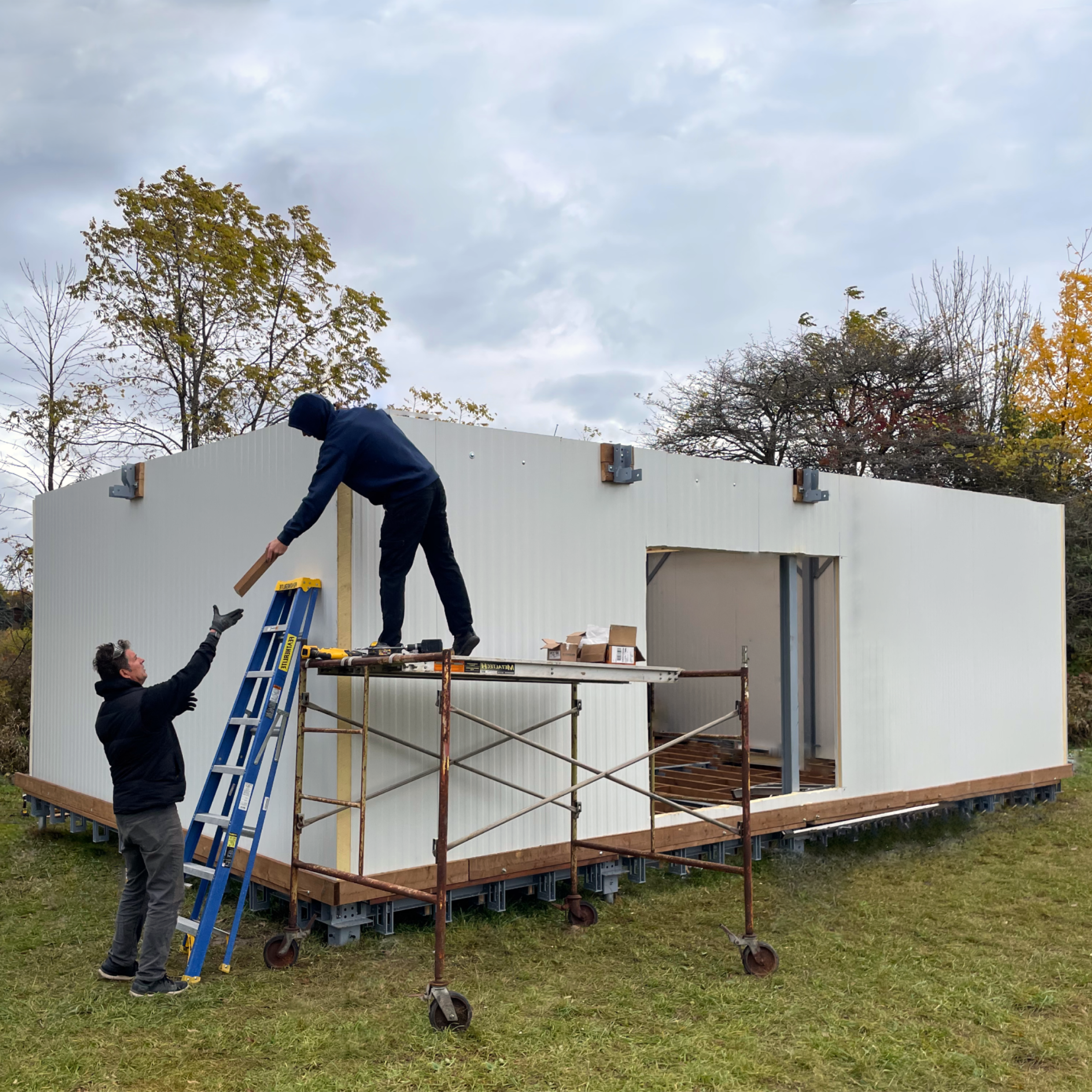 Professionals assembling Buildlite modular home shell on-site
